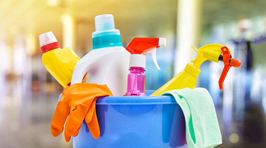 a bucket of various types of cleaning products