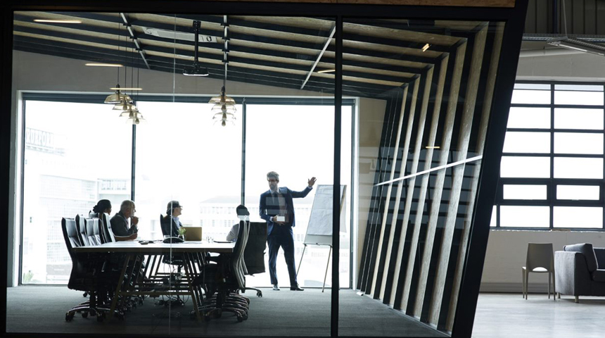 People in a glass meeting room