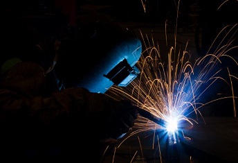 man welding in the dark